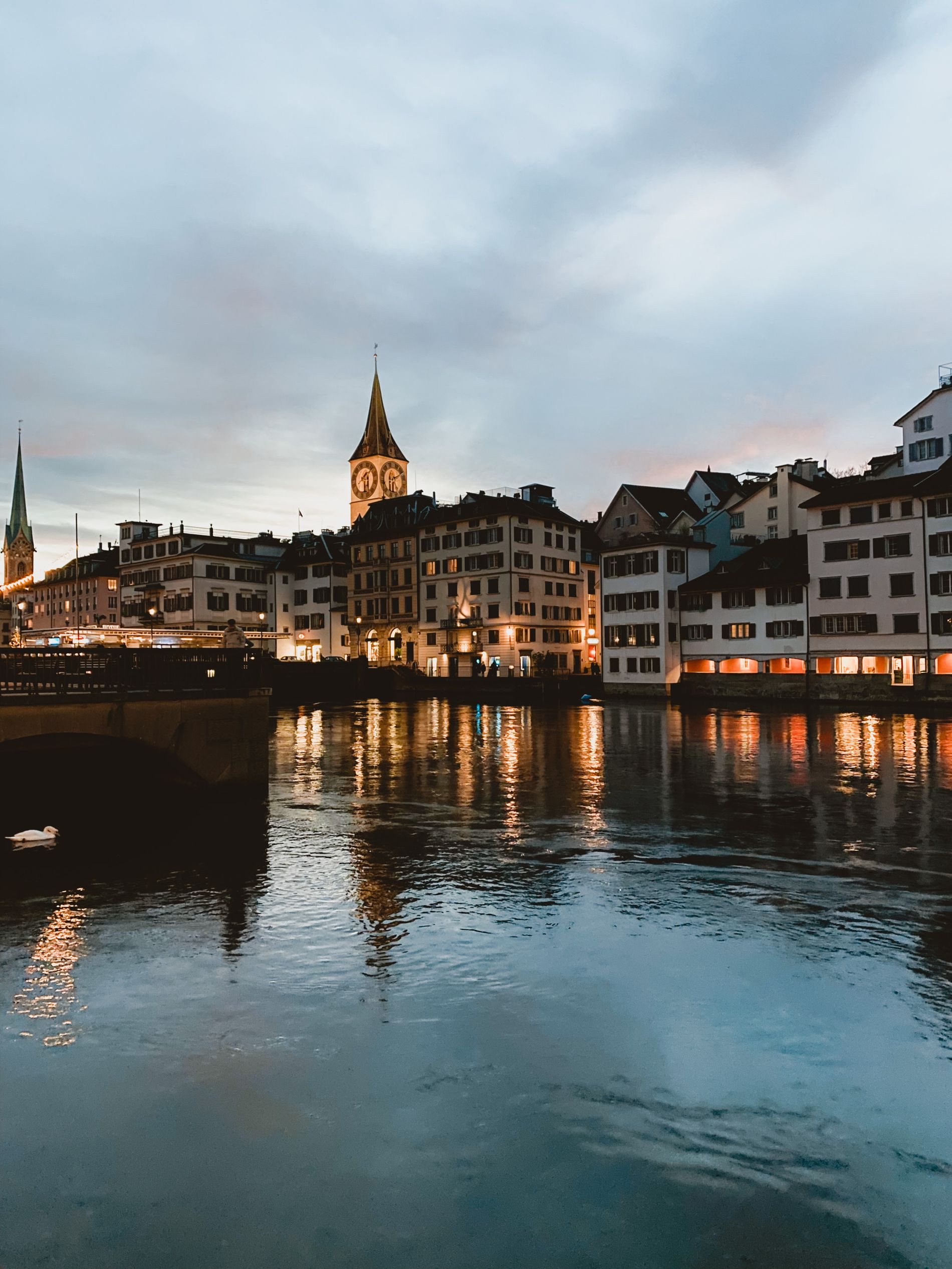 Zurich riverfront buildings lit in the evening